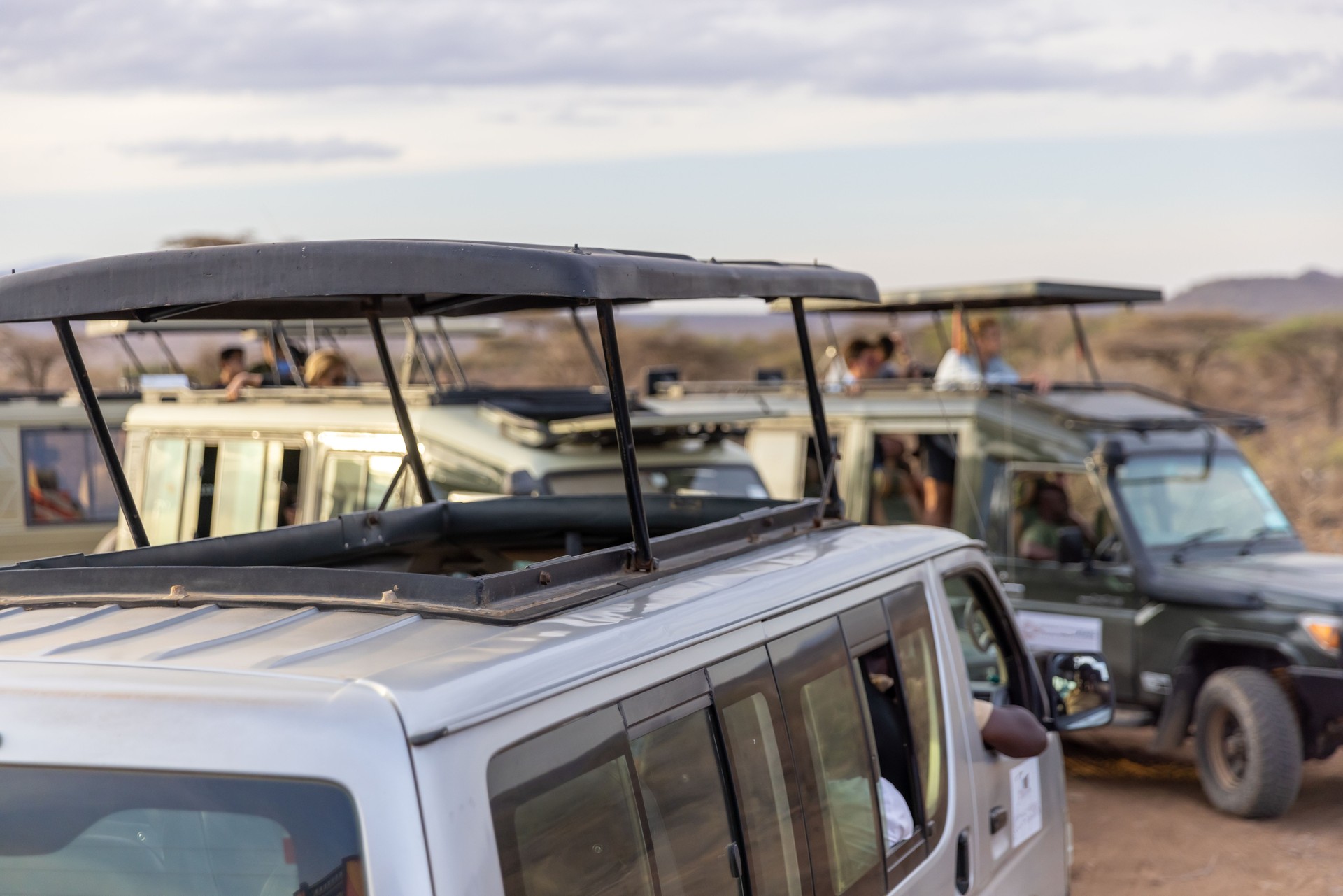 Off-road vehicles moving at National Park against cloudy sky in Kenya,East Africa